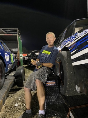 PG Racing Team 74 crew member working beside the race car